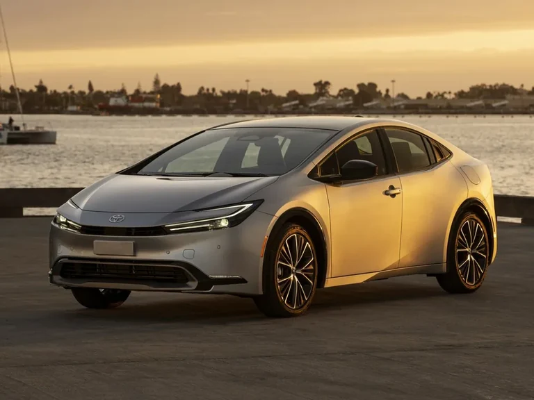 Toyota Prius пятого поколения (XW60), серебристый лифтбек на набережной, вид спереди-сбоку