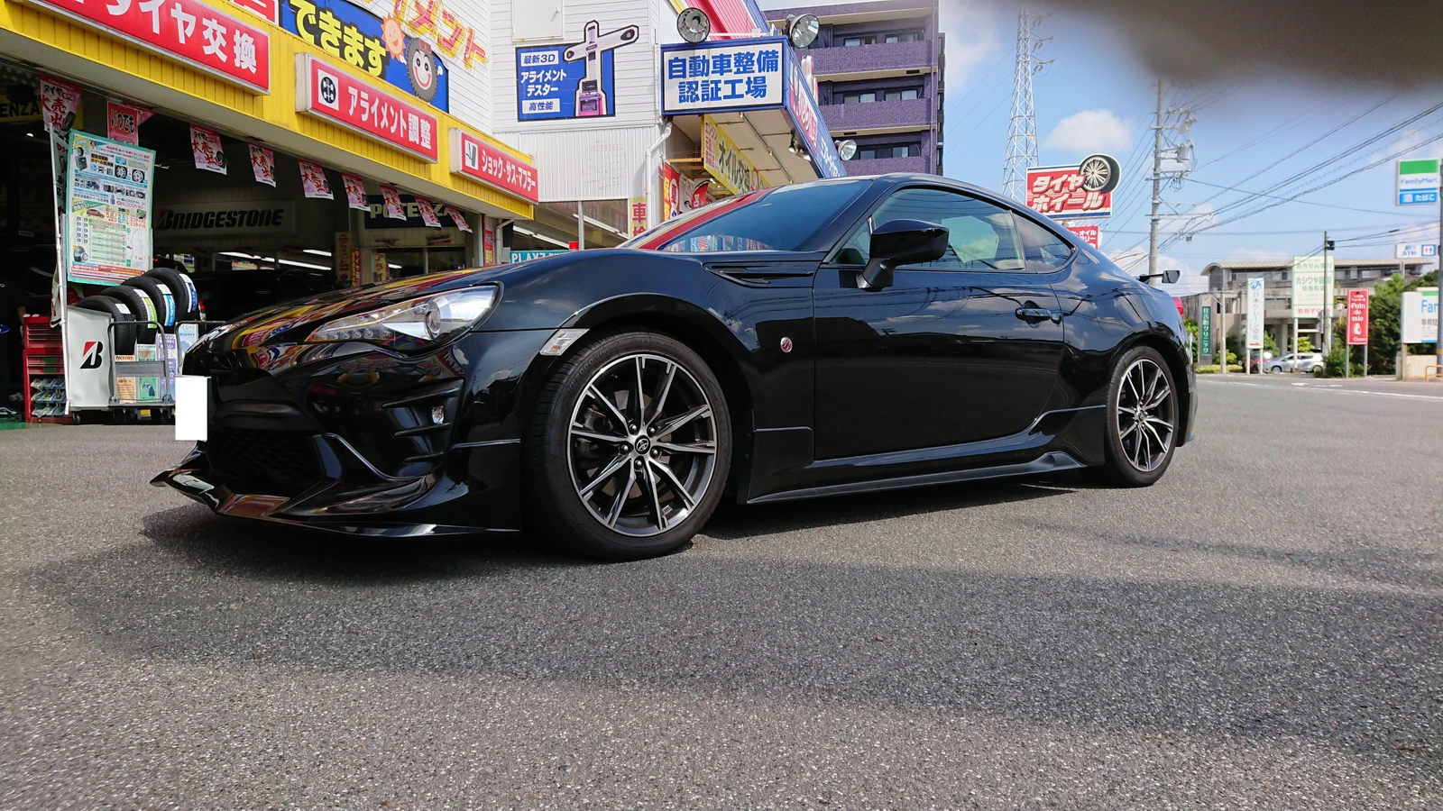 Black coupe before changing wheels